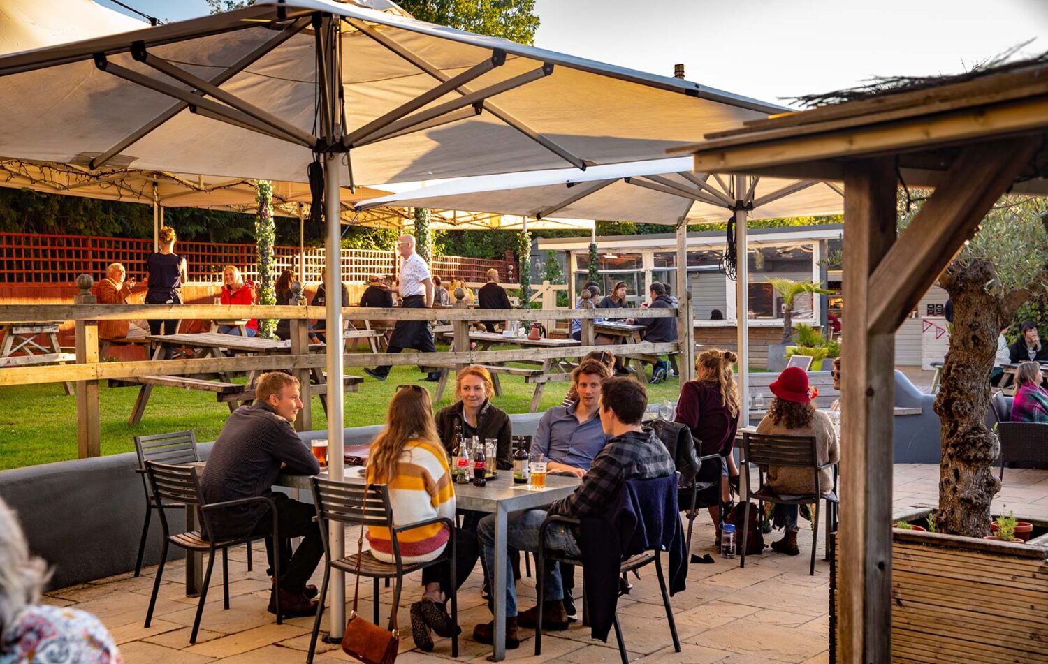 people eating and drinking outside the Cott Inn pub