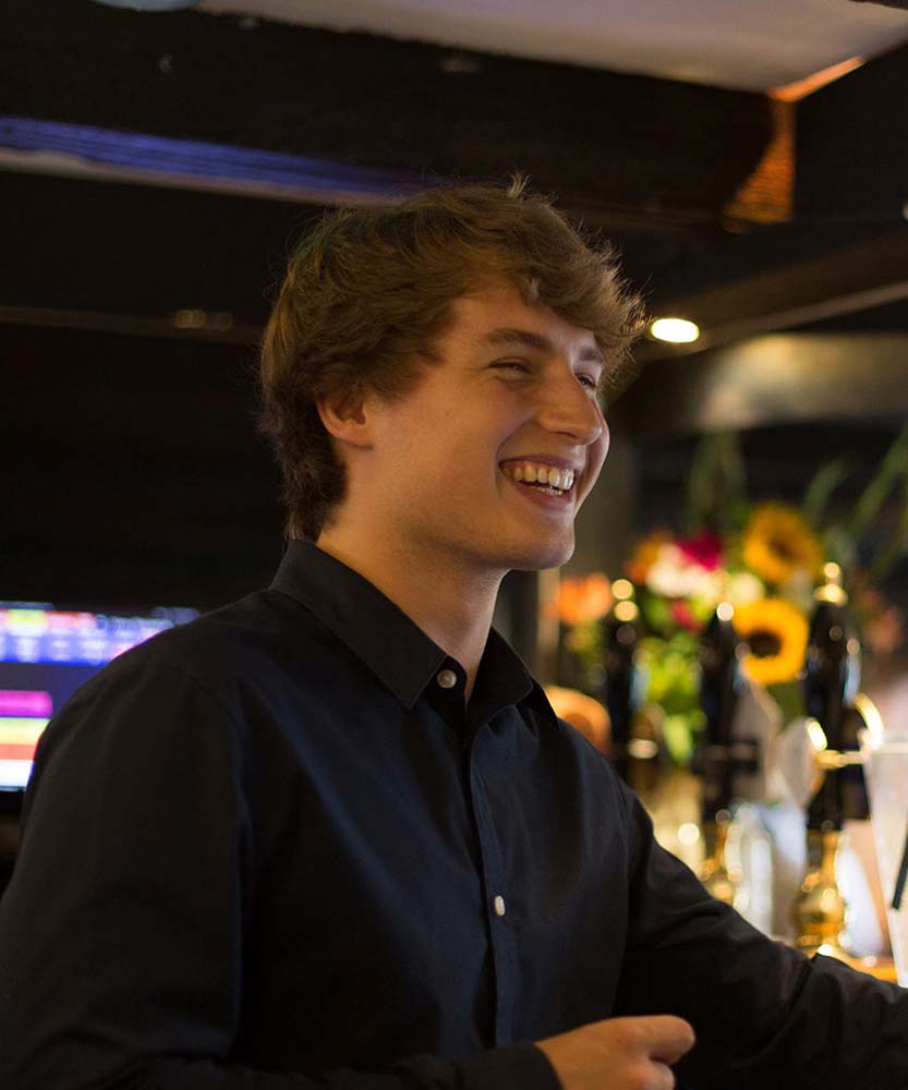 Smiling man at bar