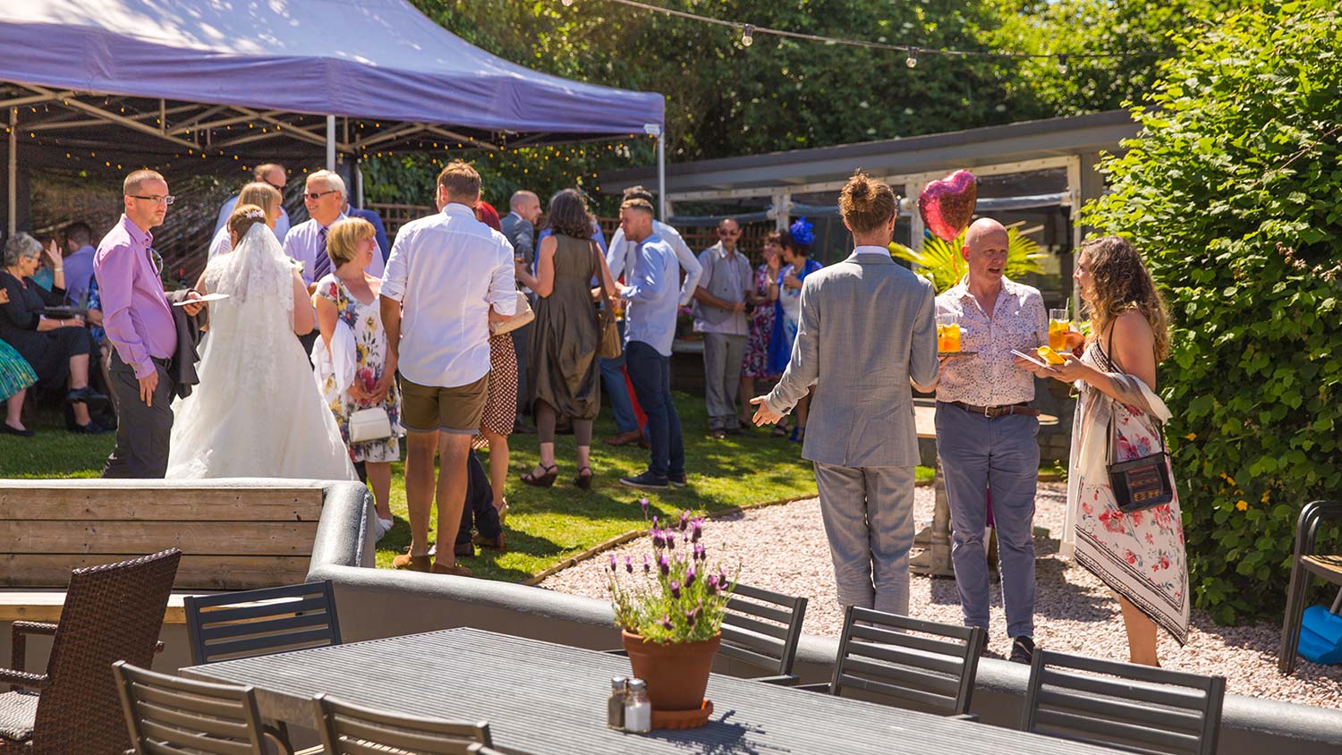 Wedding guests enjoying the sunshine